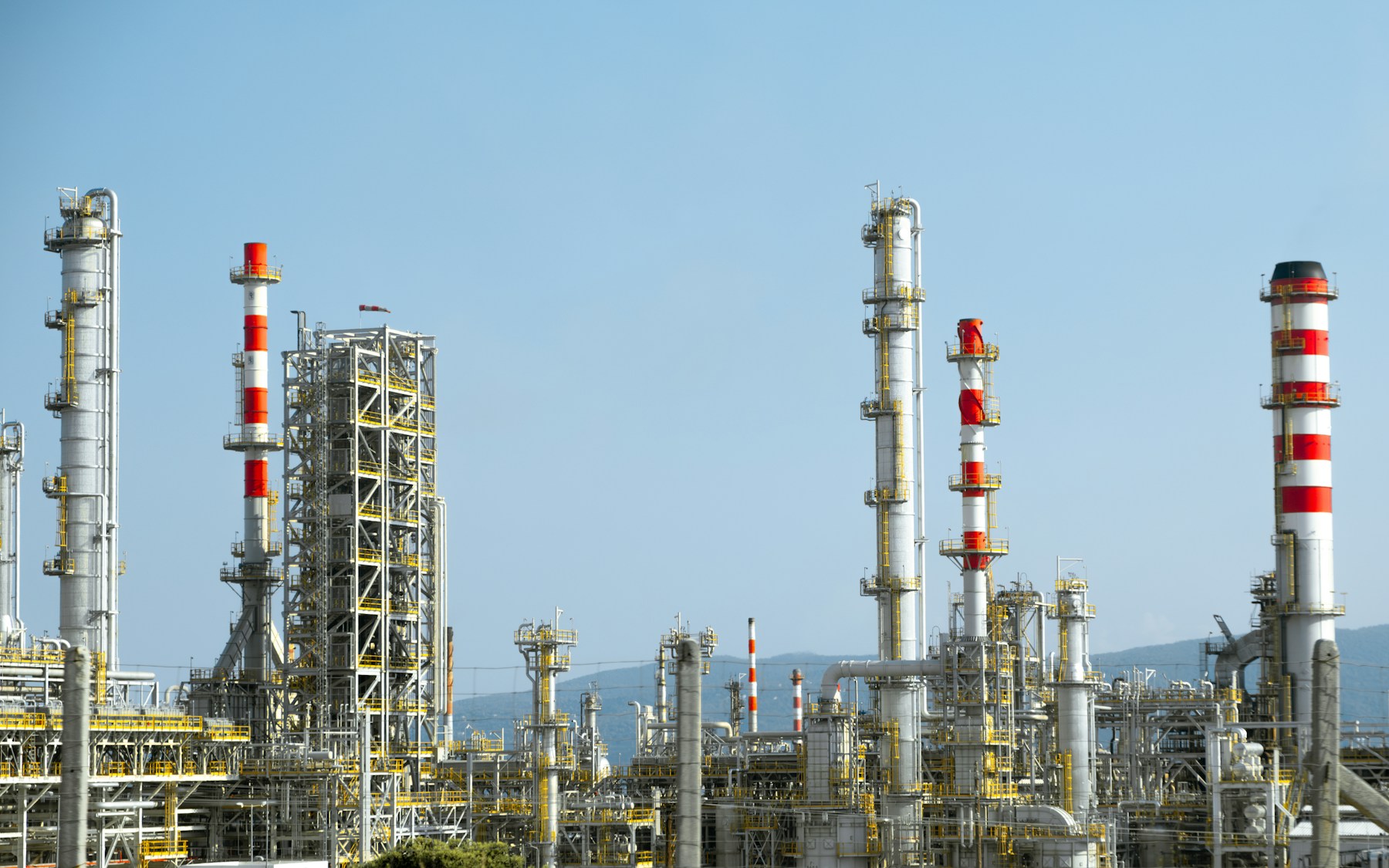 Planta industrial transnacional vista en ángulo amplio con infraestructura de tuberías y procesos